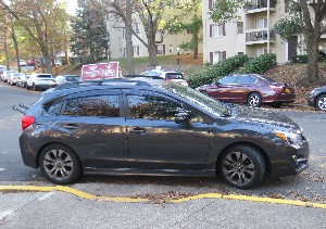 Wheelchair ramp blocked by parked car